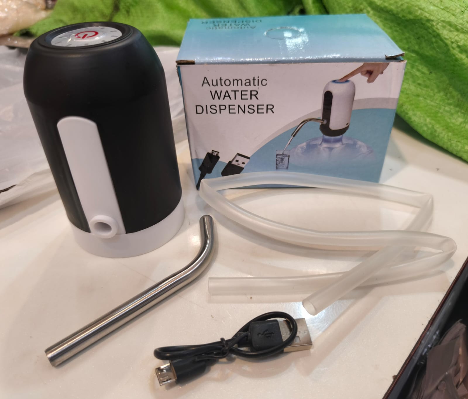 USB rechargeable smart water pump with stainless steel outlet pipe.