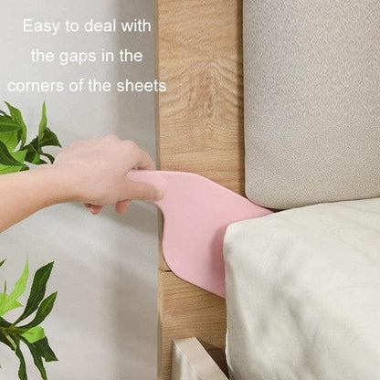 Pink bed corner gap filler being used to address sheet gaps on a bed.