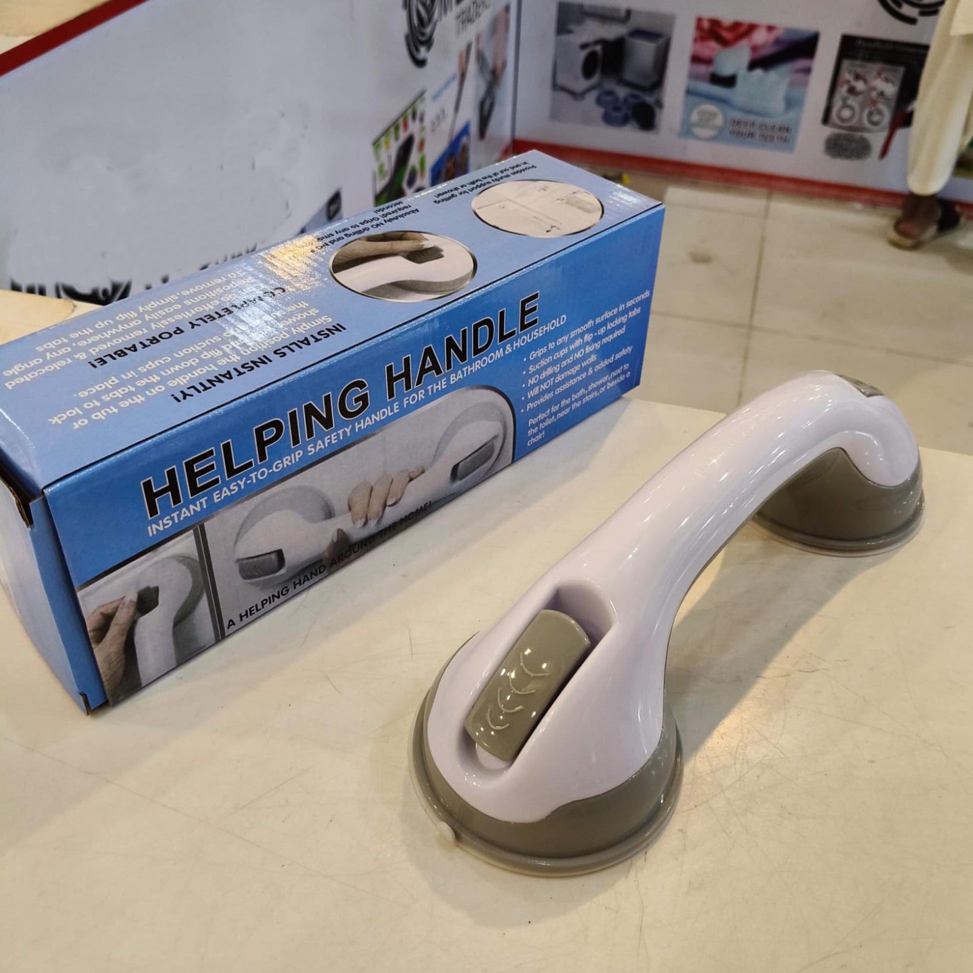 Strong suction cup safety handle in grey and white installed on bathroom tiles