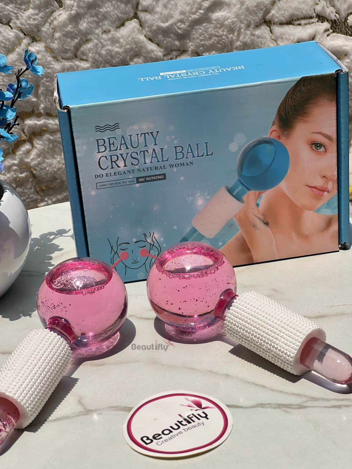 Facial ice globes in a box with protective handles for easy grip.