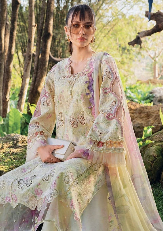 Model wearing Maria B. pastel yellow embroidered suit with butterfly motifs.