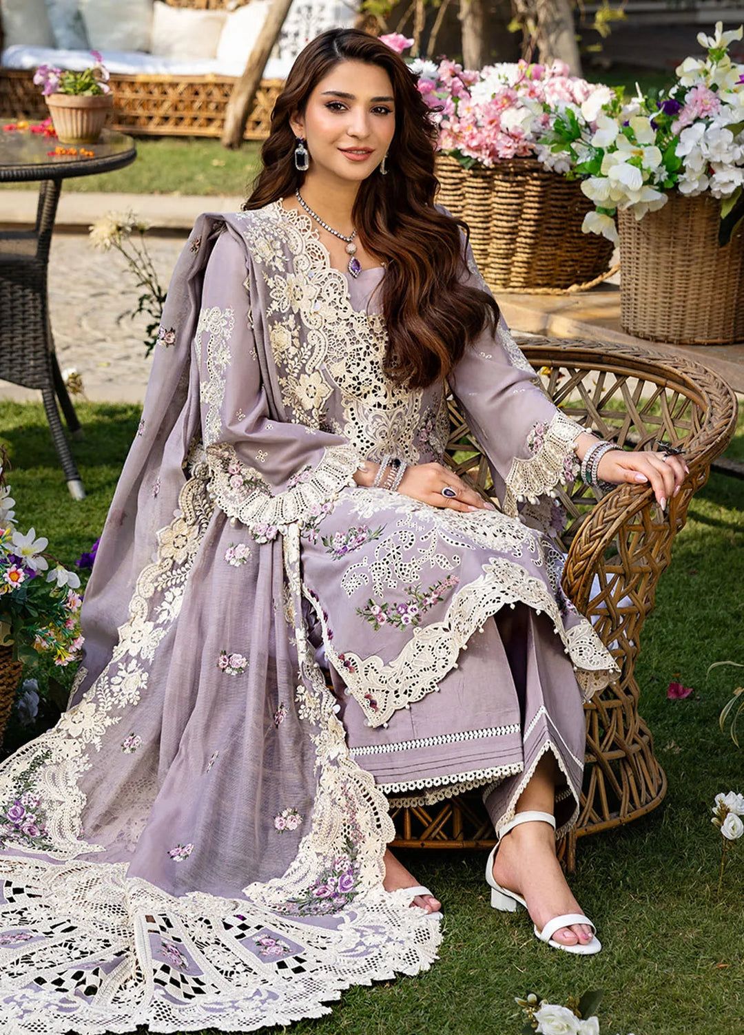 Woman wearing a luxury lavender suit with heavy floral embroidery,