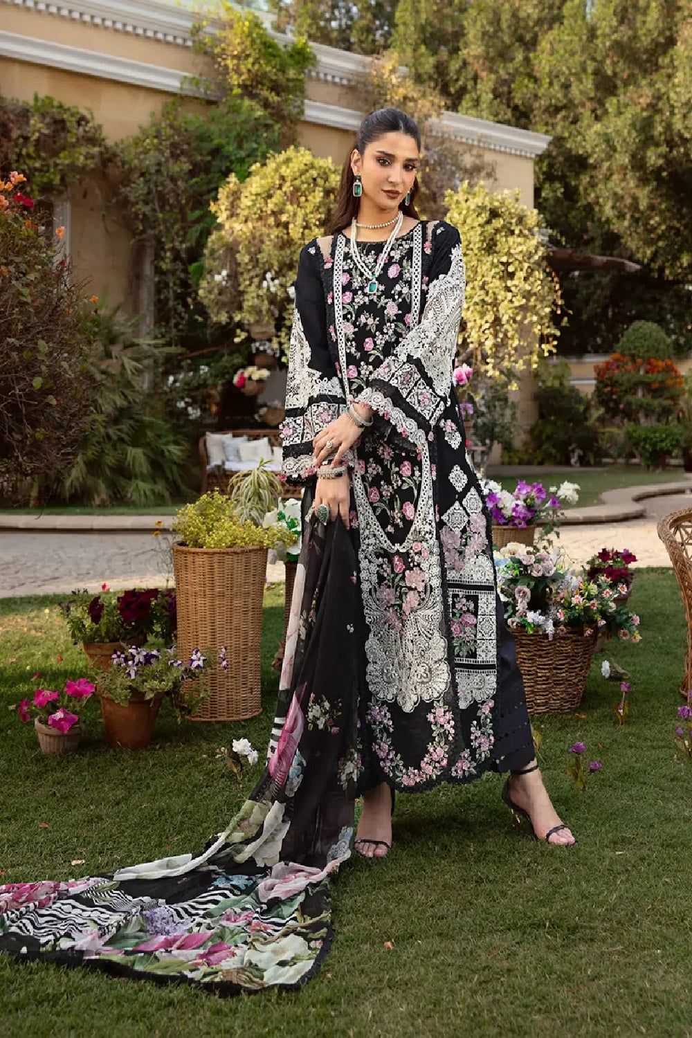 Detailed pink and green floral embroidery on a premium black festive lawn suit."