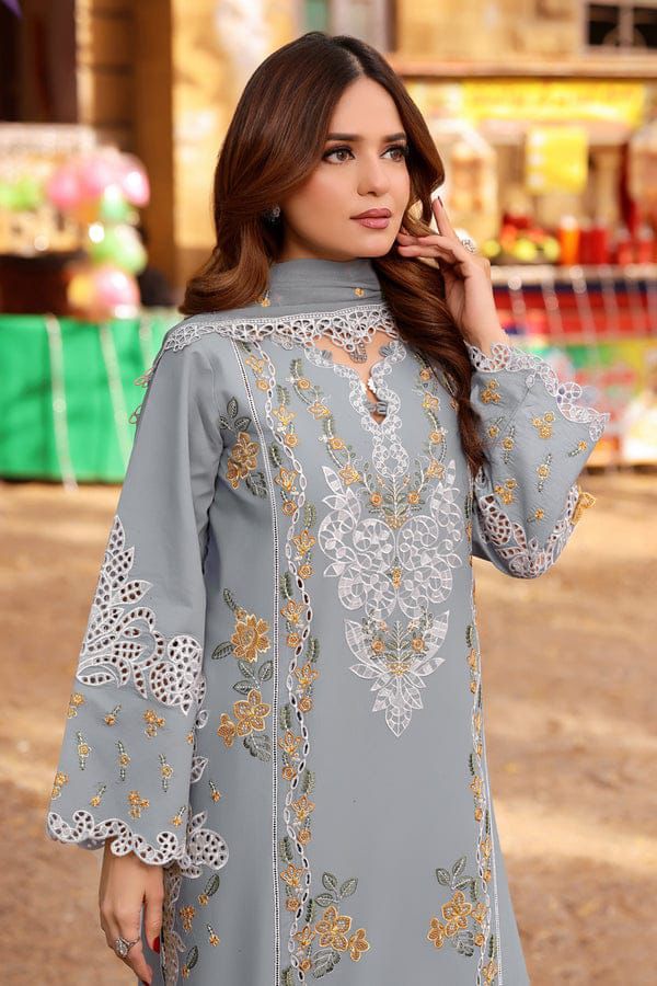 Model wearing a grey unstitched 3-piece suit with gold floral embroidery.