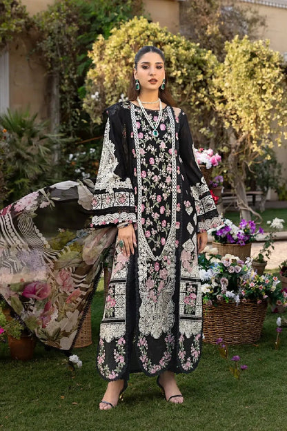Intricate white lace border and floral thread work on a high-quality black formal dress."