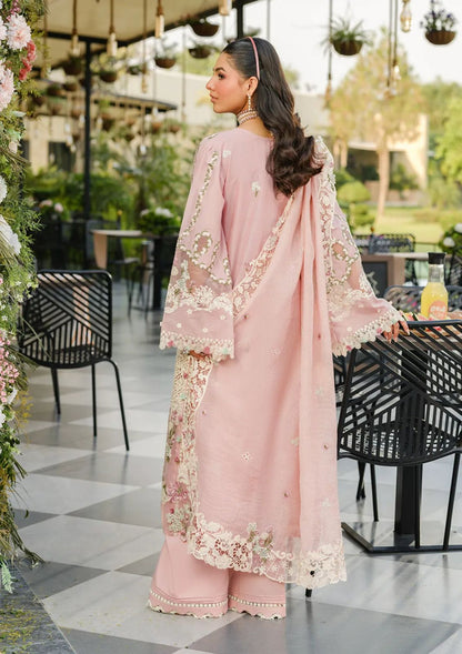 Close-up of intricate lace-trimmed dupatta and bell sleeves on a premium pink festive dress."