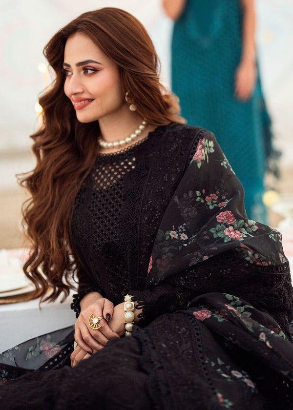 Close-up of intricate black embroidery and cutwork design on the neckline.