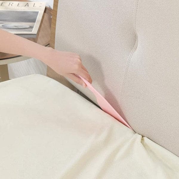 Ergonomic bedsheet helper paddle for easy bed making in a modern bedroom.