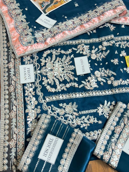 Teal blue velvet pakistani suit with a contrasting embroidered dupatta.