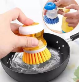 Soap-dispensing-dish-brush-cleaning-a-non-stick-pan
