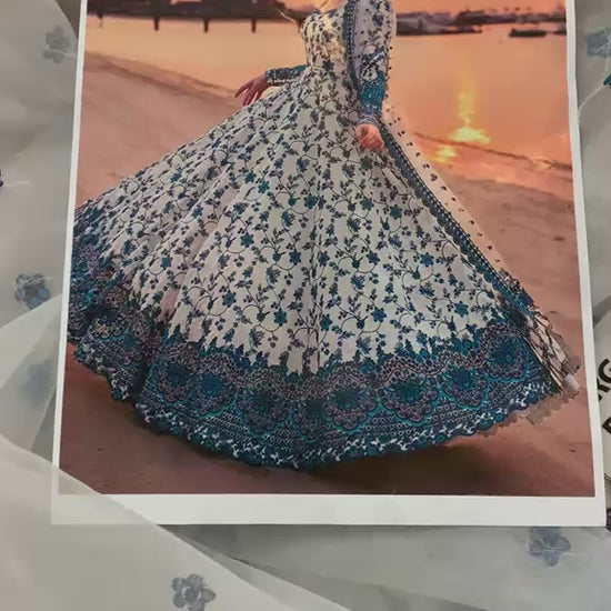 Traditional Pakistani long maxi dress with heavy blue borders for weddings.