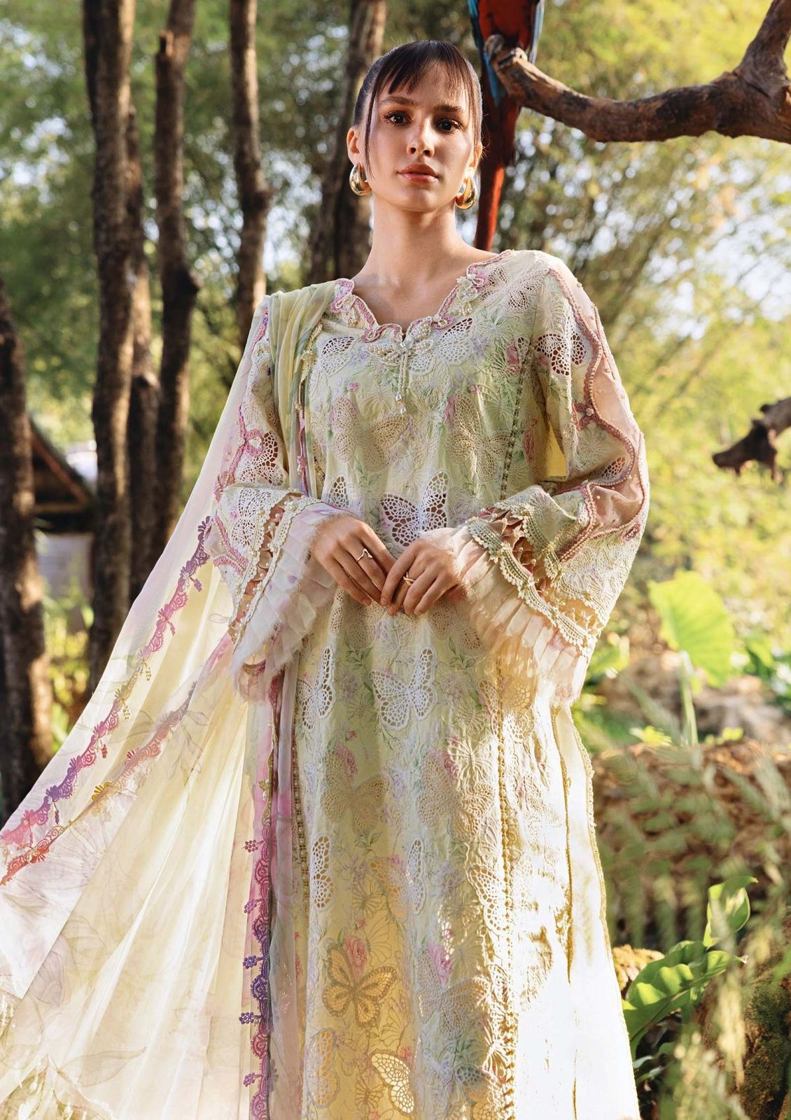 Detailed view of butterfly cutwork and organza frills on designer sleeves.